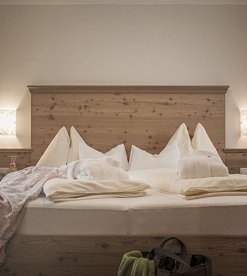 Bed in a room in the 4* star Hotel Bachmanngut