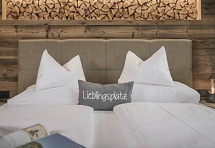 Cosy bed in the 4-star Hotel Bachmanngut at Wolfgangsee
