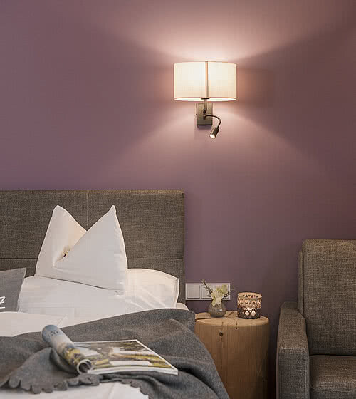 Cosy bed in the 4-star Hotel Bachmanngut at Wolfgangsee